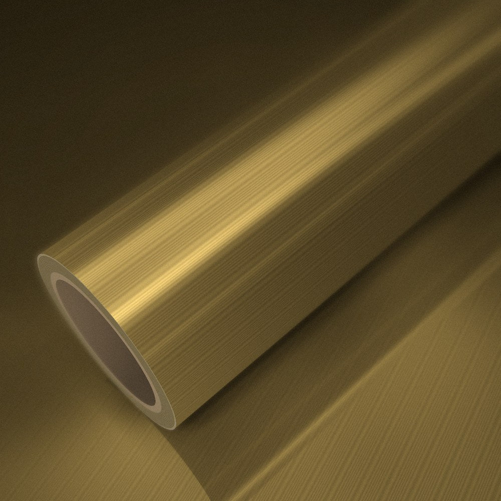 Rouleau de vinyle chrome mat or brossé posé sur une feuille du même vinyle